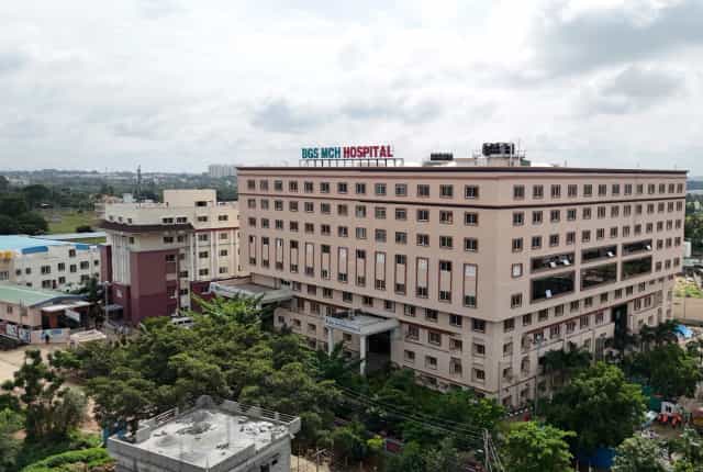 Aerial view of the BGS MCH Hospital building at Nagarur, Bengaluru North, with rooftop signage reading BGS MCH HOSPITAL