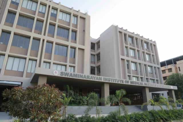 Swaminarayan Institute of Medical Sciences & Research building with façade signage, Saij, Kalol, Gandhinagar