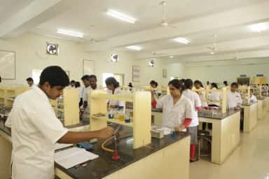 MBBS students at workbenches in a practical science laboratory at AIMS