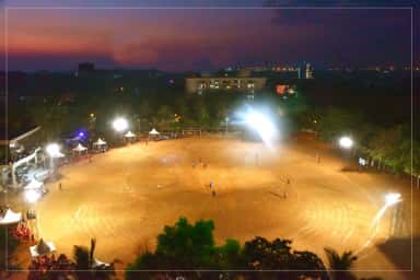 Floodlit sports ground at dusk on the AJIMS campus, Mangalore