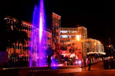 AJIMS campus building and fountain illuminated at night, Mangalore