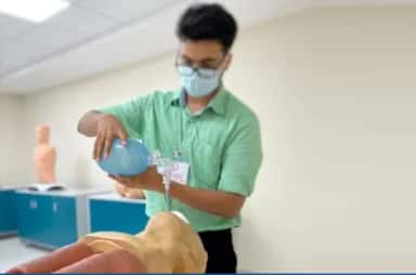 MBBS student practising bag-valve-mask ventilation on a manikin in the AJIMS skills lab