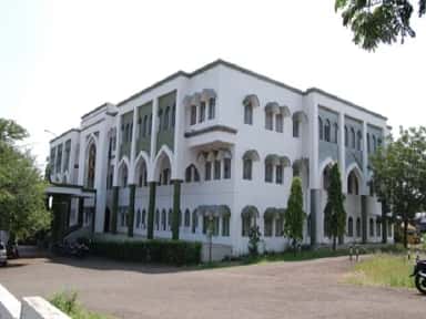 Main building of Al-Ameen Medical College, Bijapur with white-and-green Indo-Islamic arched facade