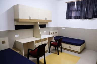 Twin-sharing hostel room with study desks at Apollo Institute of Medical Sciences and Research, Hyderabad
