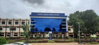 Basaveshwara Medical College Hospital building with its blue-glass facade and Kannada signage, Chitradurga