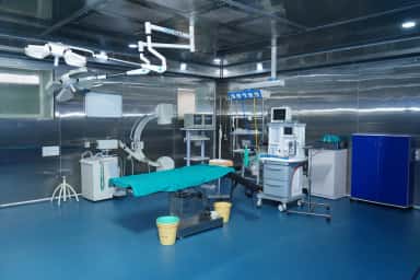 Operation theatre with surgical lights and anaesthesia workstation at Basaveswara Medical College and Hospital, Chitradurga