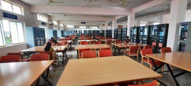 Students at reading tables in the central library of Basaveswara Medical College, Chitradurga