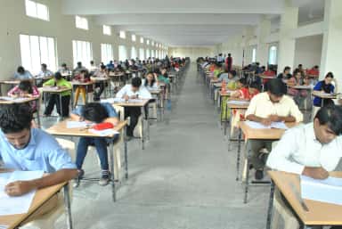 Students writing university examinations in the examination hall at Basaveswara Medical College, Chitradurga