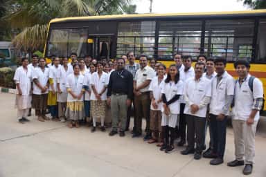 MBBS students and faculty of BGS Medical College and Hospital beside the college bus before a community medicine field visit