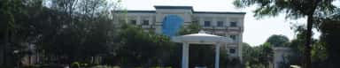 Bhaskar General Hospital building behind trees with white gazebo in front, Yenkapally campus, Moinabad