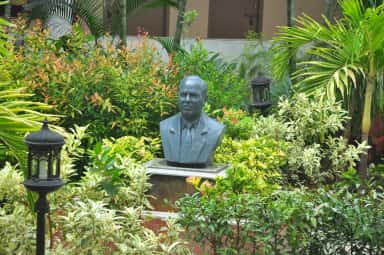 Bust of founder Sri J. Bhaskar Rao amid the campus gardens at Bhaskar Medical College