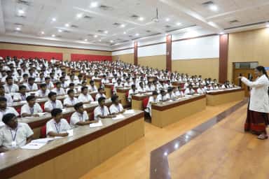 Tiered lecture hall full of students with a faculty member teaching at Chettinad Hospital and Research Institute