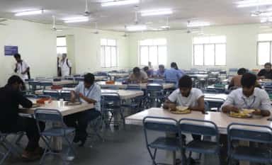 Students dining in the hostel mess hall at Chettinad Hospital and Research Institute, Kelambakkam