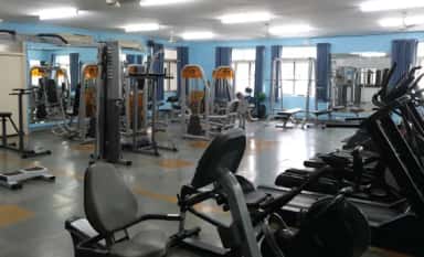 Gymnasium with strength and cardio equipment on the Chettinad Health City campus, Kelambakkam