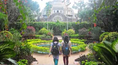 Students walking through the campus garden towards the heritage College Chapel at Christian Medical College, Vellore