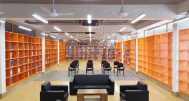 Central library reading area with orange book stacks at Datta Meghe Medical College, Nagpur