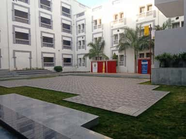 On-campus Shivneri hostel residential block with paved courtyard at Datta Meghe Medical College, Nagpur