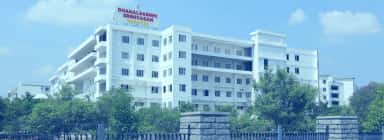 Main academic building of Dhanalakshmi Srinivasan Medical College, Siruvachur, with the college name on the rooftop