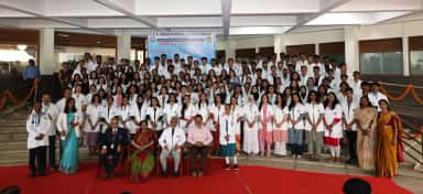 MBBS students and faculty at the white coat ceremony on the college steps, Dr. B.R. Ambedkar Medical College & Hospital, Bengaluru