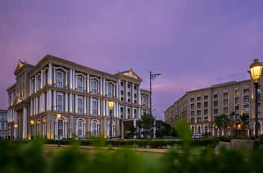 CDSIMER campus buildings at dusk seen across the lawns, Harohalli