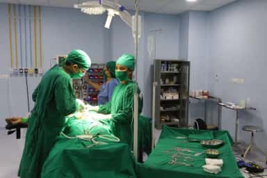 A surgical team operating in a modular operation theatre at Dr. N. D. Desai Hospital, Nadiad