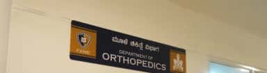 Bilingual Department of Orthopedics signboard inside FAME Hospital, Mysuru
