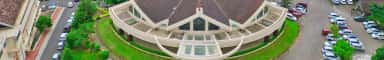 Aerial view of the curved chapel-fronted block and lawns on the Father Muller Medical College campus, Mangalore