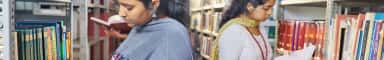 Students browsing the book stacks of the Central Library at Father Muller Medical College, Mangalore