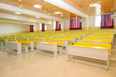 Tiered lecture hall with yellow benches at GR Medical College Mangalore