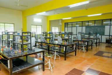 Practical laboratory with covered apparatus and examination notes on the blackboard, GR Medical College Mangalore