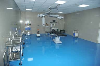 Modular operation theatre with overhead surgical lights and equipment at Indira Medical College & Hospitals, Thiruvallur