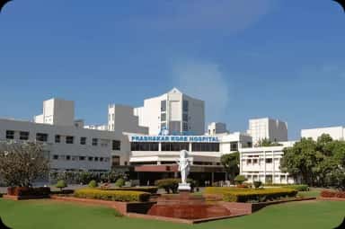 KLES Dr. Prabhakar Kore Hospital & Medical Research Centre building with lawns in Belagavi, the teaching hospital of Jawaharlal Nehru Medical College