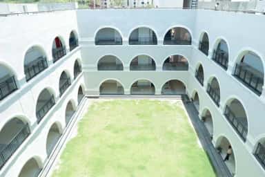 Three-storey arched inner courtyard with lawn at KLE JGMM Medical College, Hubballi