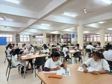 Students studying at long tables in the reading hall of KLE JGMM Medical College, Hubballi