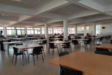 Student dining hall with tables and chairs at KLE JGMM Medical College, Hubballi