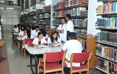 MBBS students in white coats studying in the central library of JJM Medical College Davangere