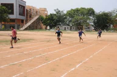 Students running a relay race on the JSS Medical College sports ground, Mysuru