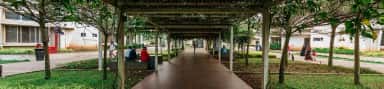 Tree-covered pergola walkway between buildings on the Nitte Deralakatte campus of K S Hegde Medical Academy