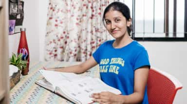 Student studying at a desk in a hostel room at K S Hegde Medical Academy, Mangalore