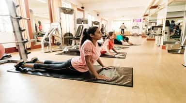 Students stretching on mats in the campus gym at K S Hegde Medical Academy, Mangalore