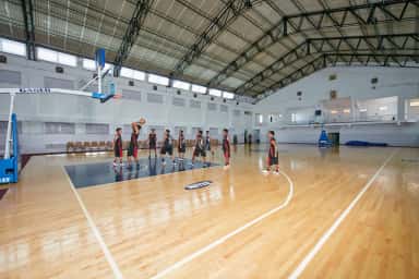 Students playing basketball in the NITTE indoor sports complex on the Deralakatte campus of K S Hegde Medical Academy
