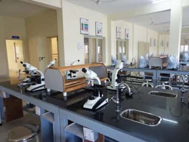 Laboratory benches lined with binocular microscopes at Kamineni Academy of Medical Sciences, Hyderabad