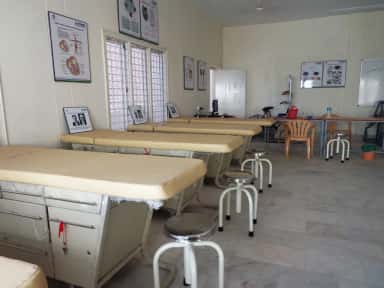 Clinical examination skills room with examination couches and anatomy charts at Kamineni Academy of Medical Sciences, Hyderabad