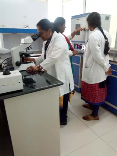 Students at laboratory benches with microscopes in a teaching laboratory at Karpaga Vinayaga Institute of Medical Sciences