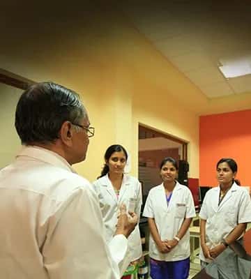 A senior professor interacting with medical students at Kasturba Medical College Mangalore