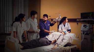 Students training on a patient simulator mannequin in a KMC Manipal clinical simulation lab
