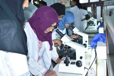 MBBS students at microscopes in a teaching laboratory at KBN University Faculty of Medical Sciences