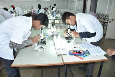 Students working with microscopes in the physiology laboratory at KBN medical college, Gulbarga