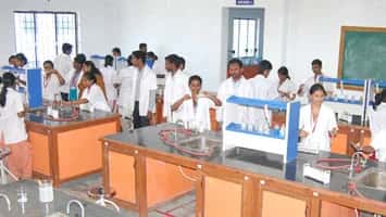 Students in white coats working at benches in a teaching laboratory at Madha Medical College and Hospital, Chennai