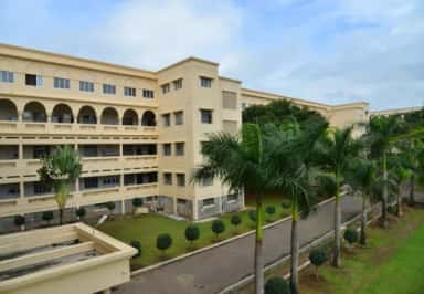 MIMER Medical College academic building with arched corridors and palm-lined avenue, Talegaon Dabhade